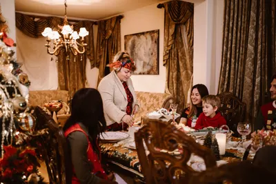 Große Familie sitzt gemeinsam am gedeckten Weihnachtstisch