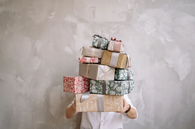 Verpackte Weihnachtsgeschenke, die nach Empfänger sortiert bereitliegen