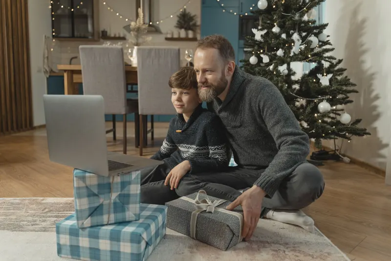 Familie plant Weihnachtsgeschenke gemeinsam am Laptop