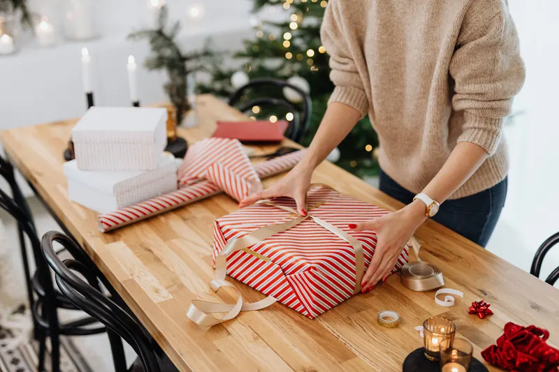 Person verpackt ein reserviertes Geschenk Person verpackt ein reserviertes Geschenk